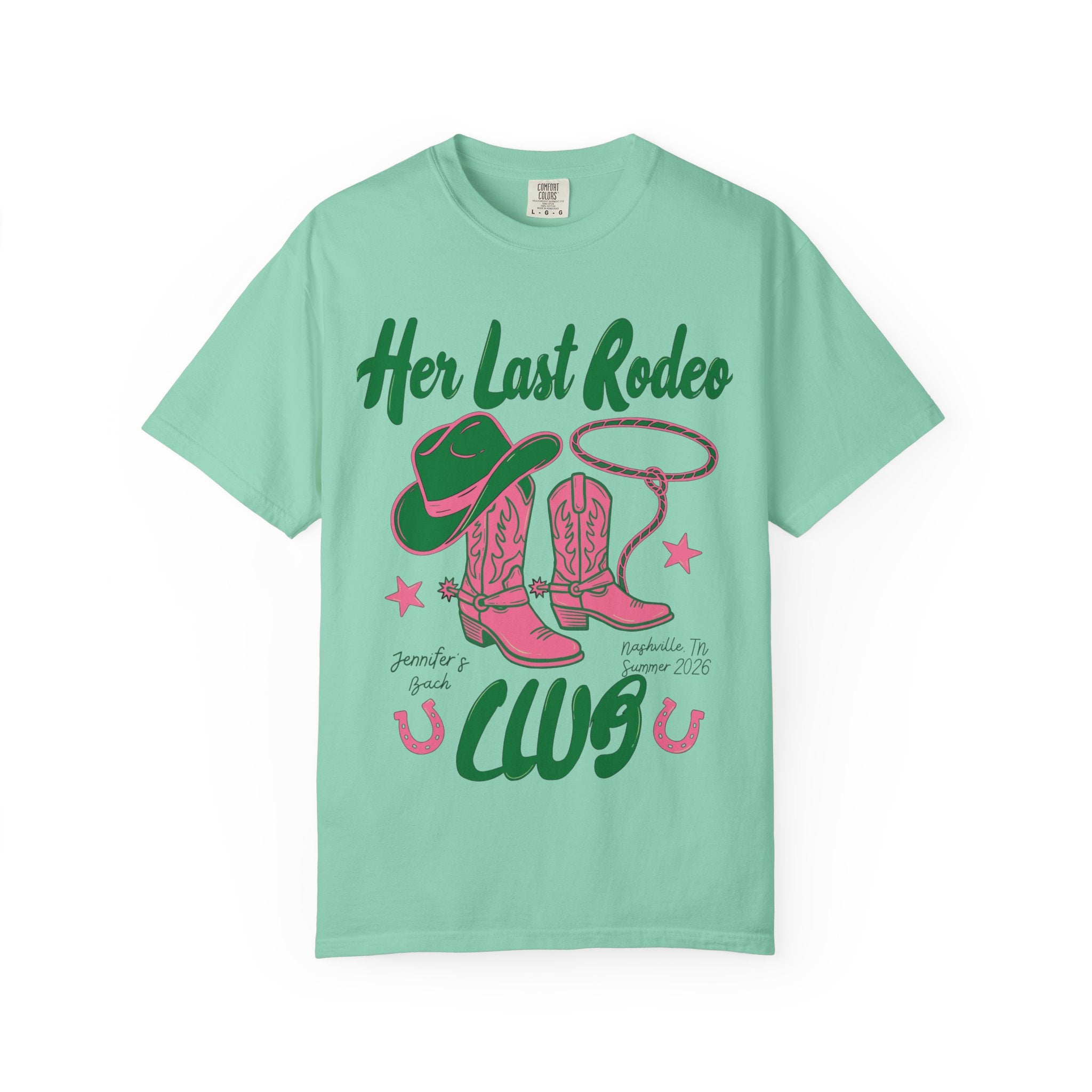 Green t-shirt with "Her Last Rodeo" text, cowboy boots, hat, and lasso.