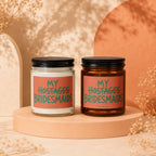 Two candles with "MY HOSTAGES BRIDESMAIDS" text on coral labels.