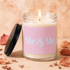 Candle with a lit wick and a pink label reading "Mr & Mr VOWED".