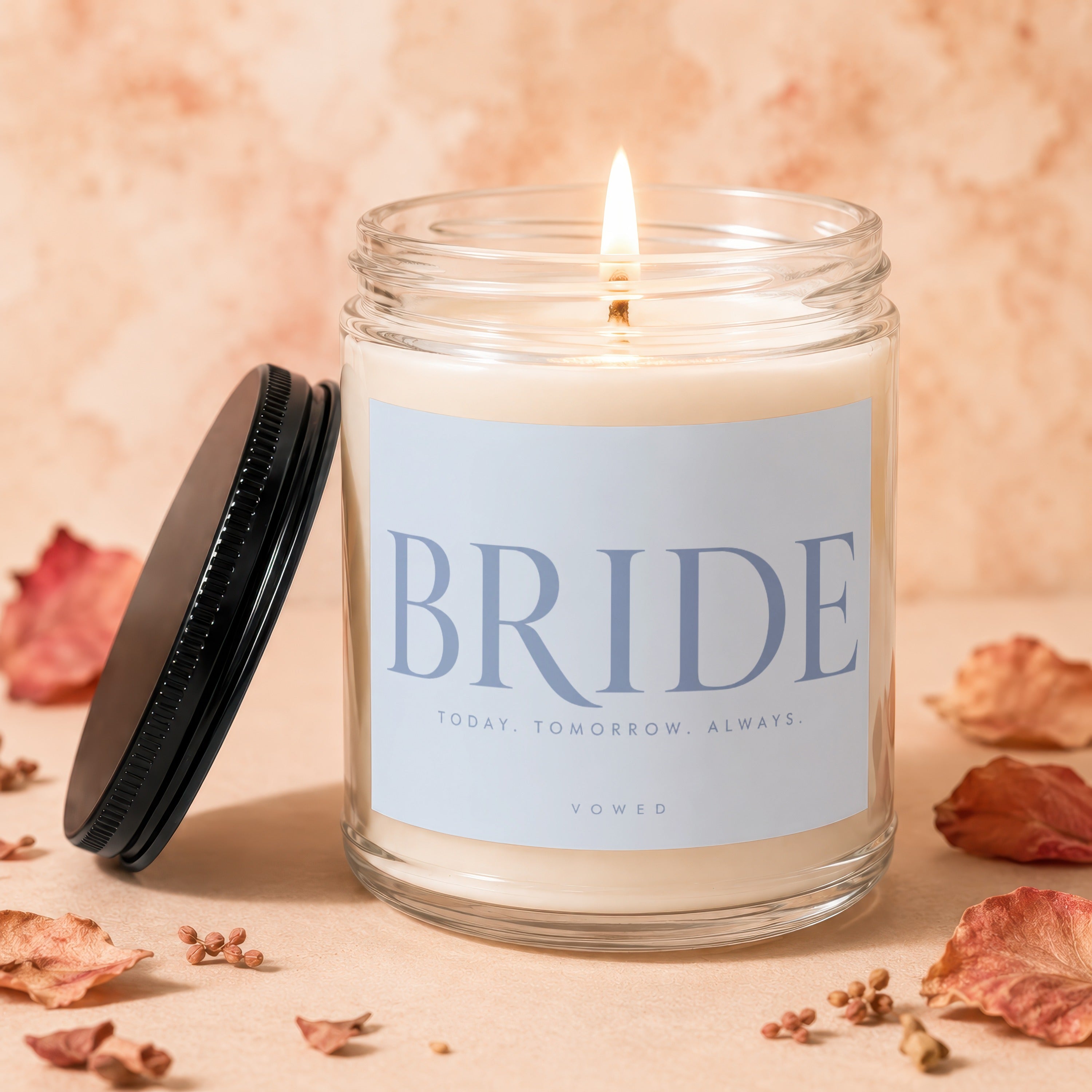Lit "BRIDE" candle with "Today. Tomorrow. Always. Vowed." text.