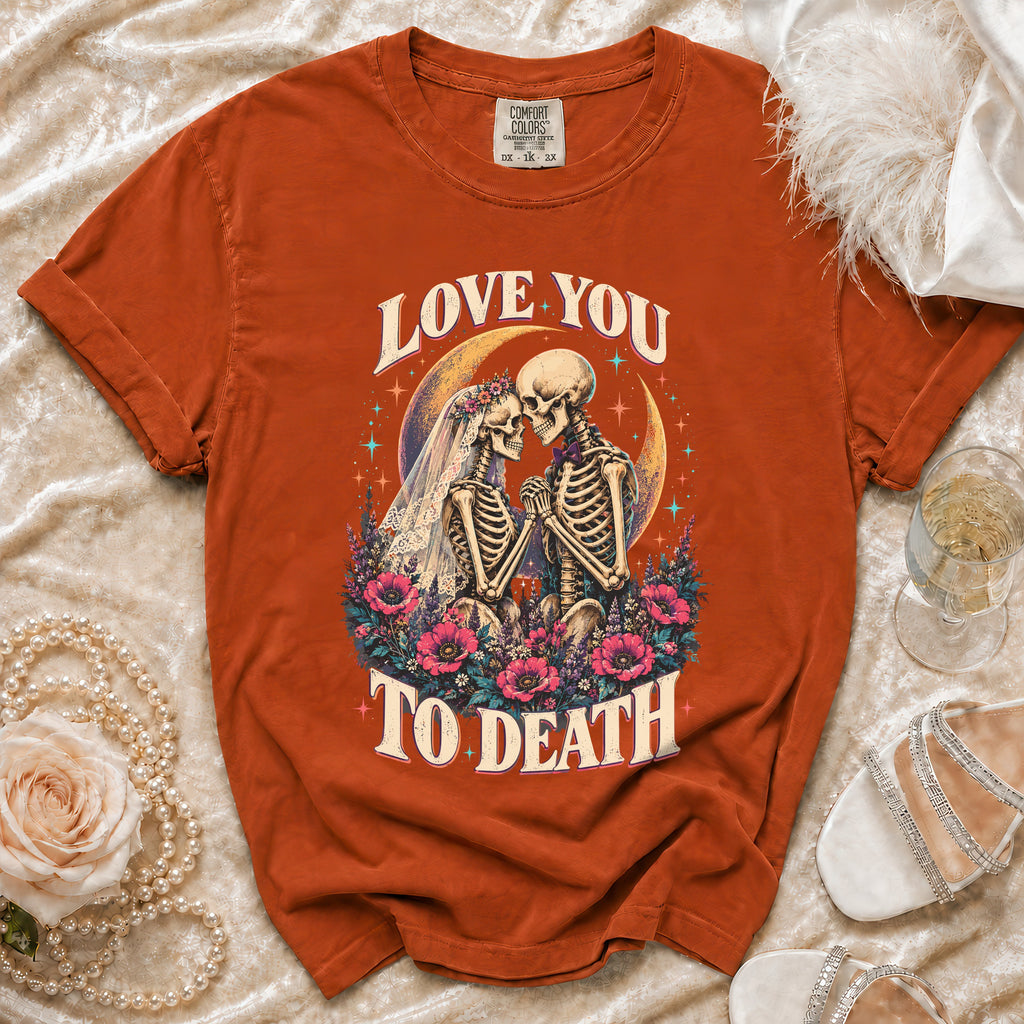 Orange t-shirt with skeletons in wedding attire, "LOVE YOU TO DEATH" text, and floral design.