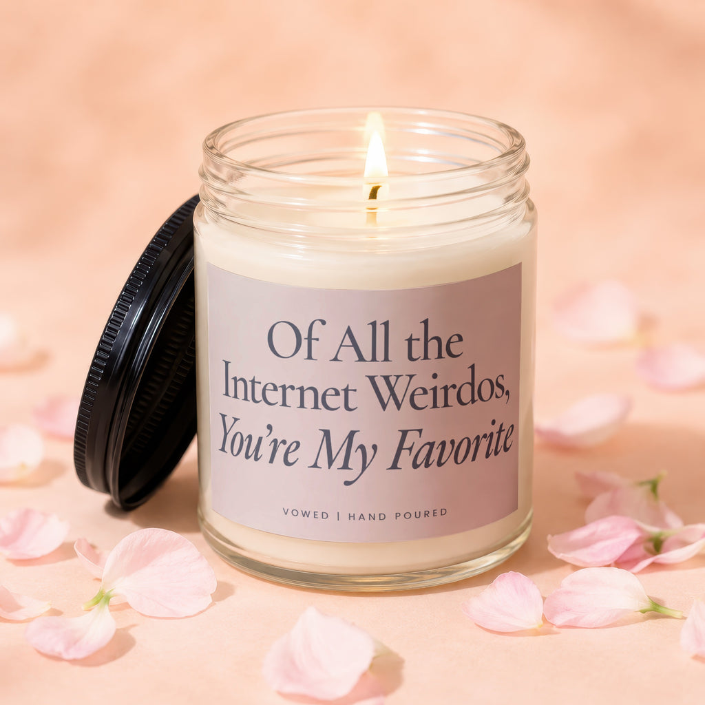 Glass candle with a lit wick and a label reading "Of All the Internet Weirdos, You're My Favorite."