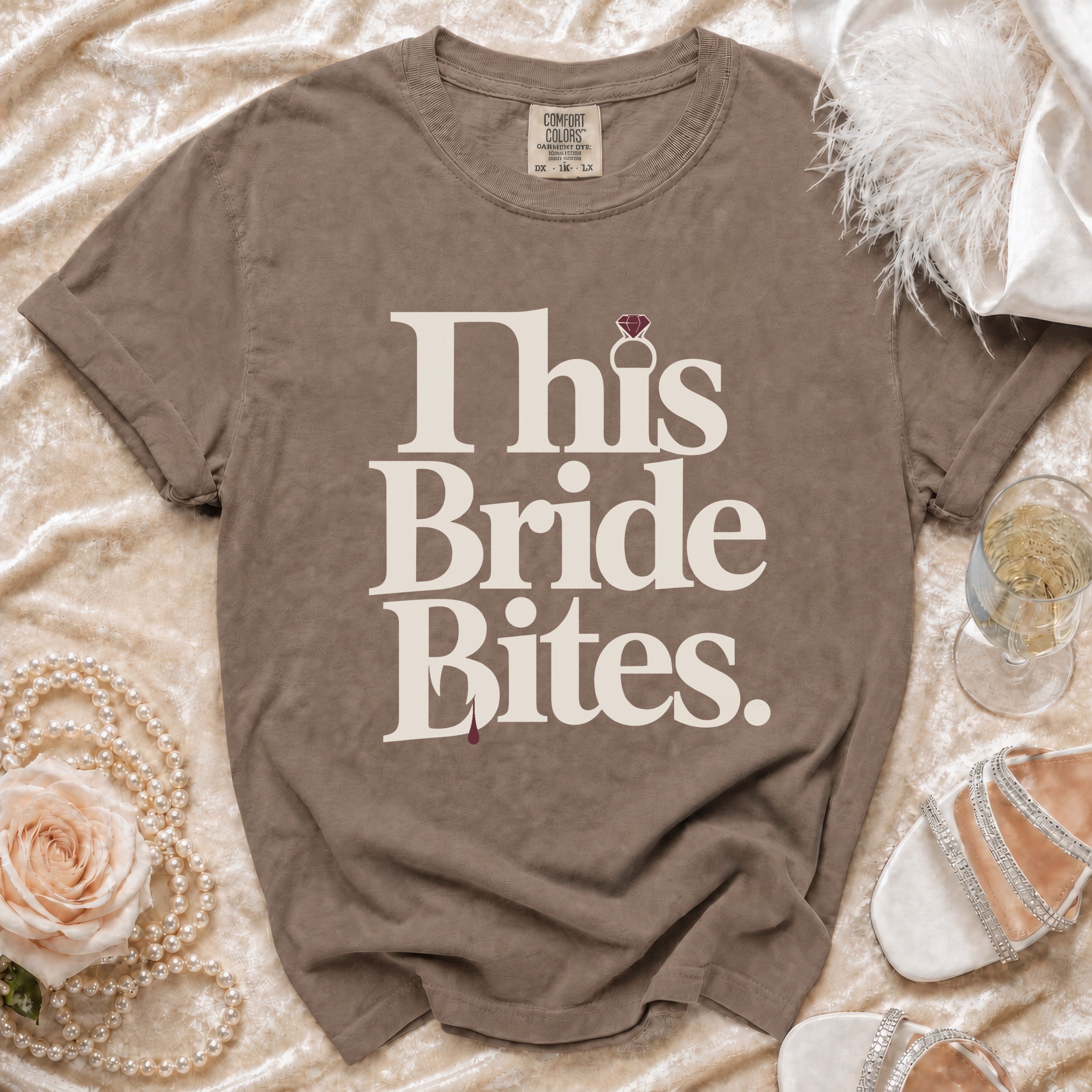 Brown t-shirt with "This Bride Bites" text and a diamond ring graphic.