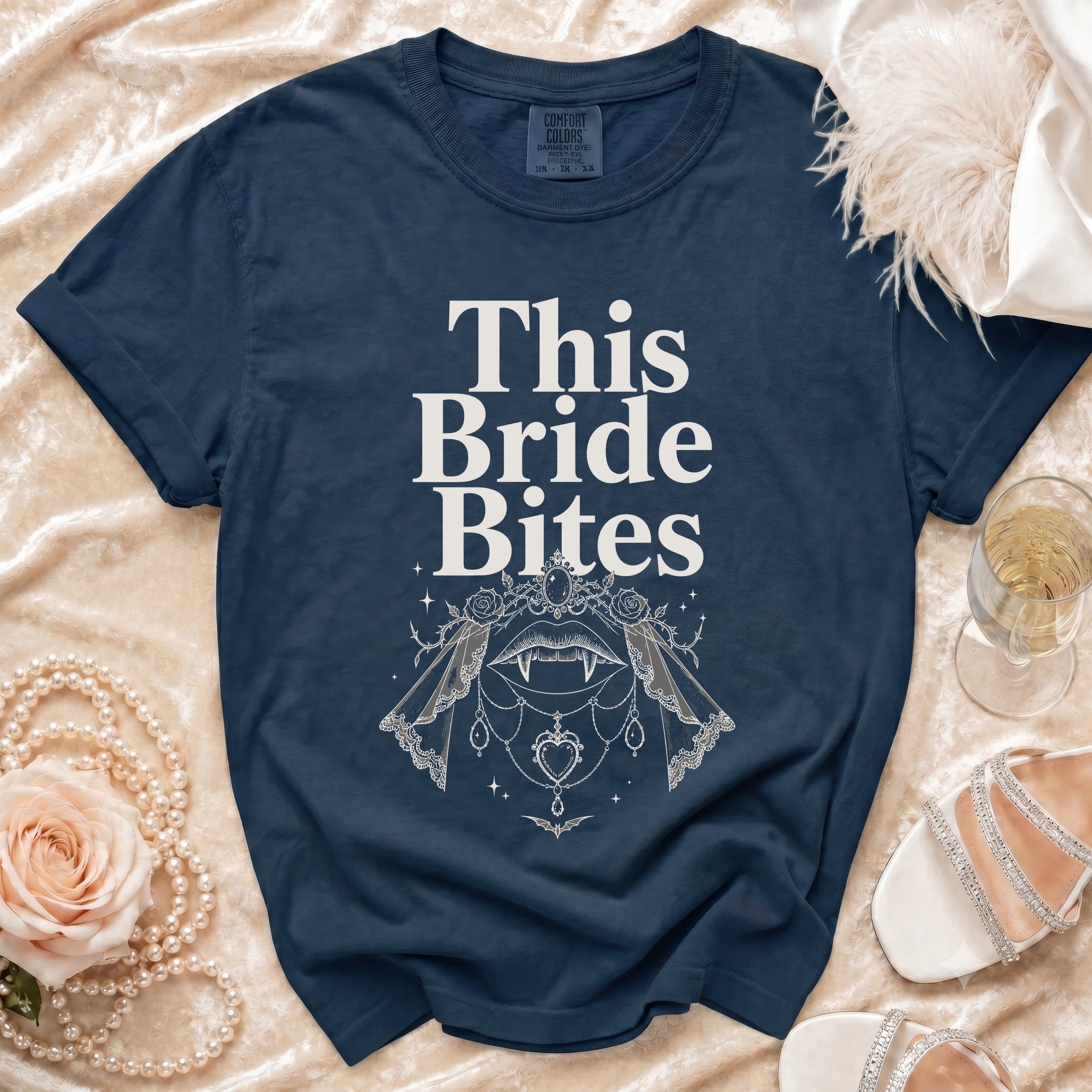 Navy t-shirt with "This Bride Bites" text and vampire fangs graphic.
