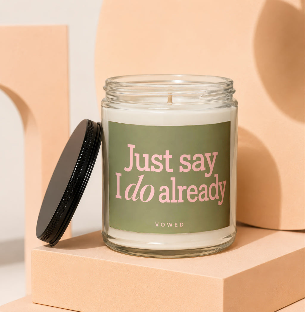 Glass candle with green label reading "Just say I do already" and "vowed".