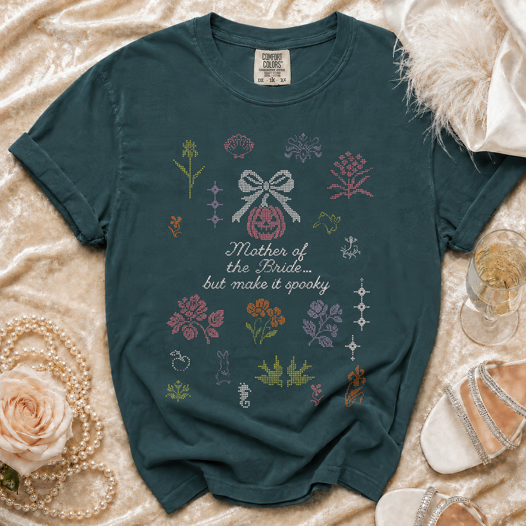 Green t-shirt with "Mother of the Bride... but make it spooky" text and embroidered motifs.