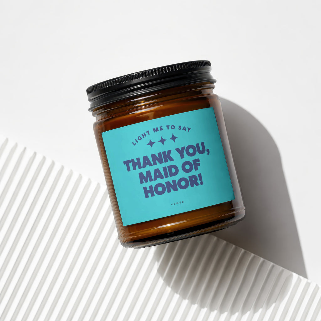 Amber glass candle with a teal label reading "Thank You, Maid of Honor!"