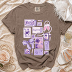 Brown t-shirt with purple honeymoon themed graphics, including tickets, stamps, and postcards.