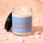 Jar candle with burning wick and label reading "Dress? Check. Tears? Check. VOWED."