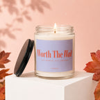 Glass candle with "Worth The Wait" label, lid removed, autumn decor.