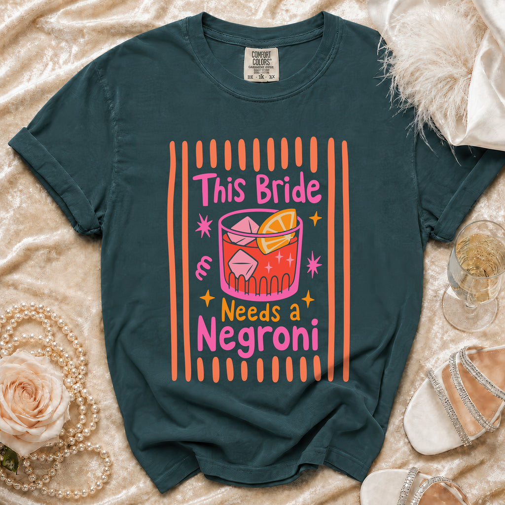 Dark teal t-shirt with "This Bride Needs a Negroni" text and cocktail graphic.