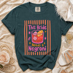 Dark teal t-shirt with "This Bride Needs a Negroni" text and cocktail graphic.