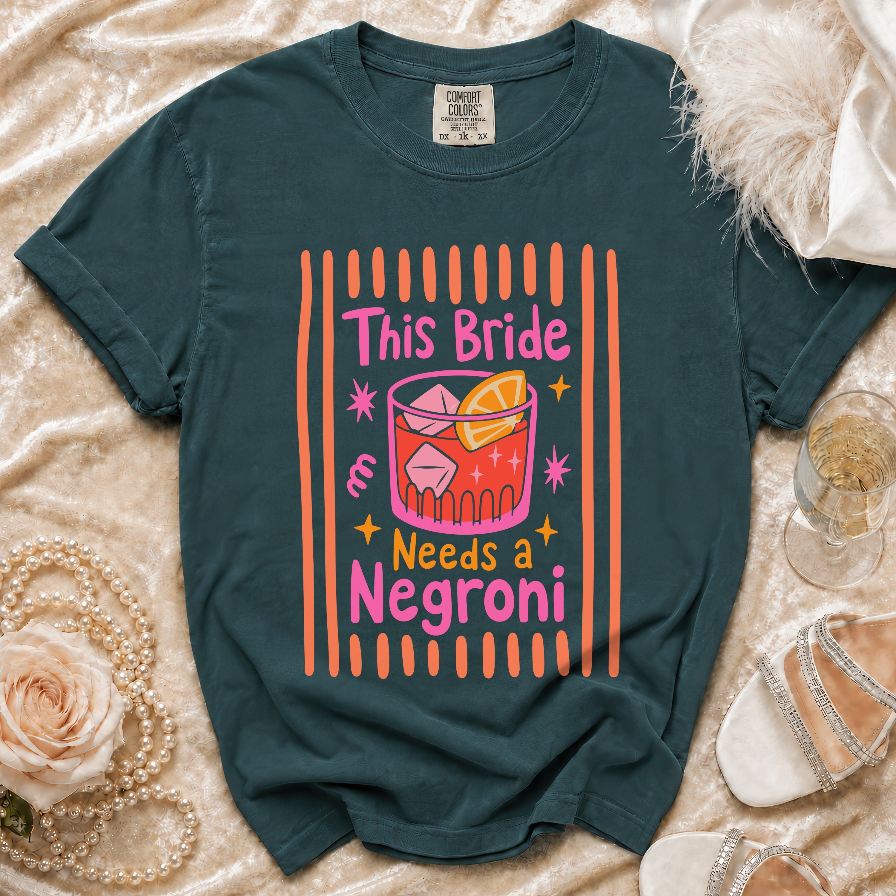 Dark teal t-shirt with "This Bride Needs a Negroni" text and cocktail graphic.