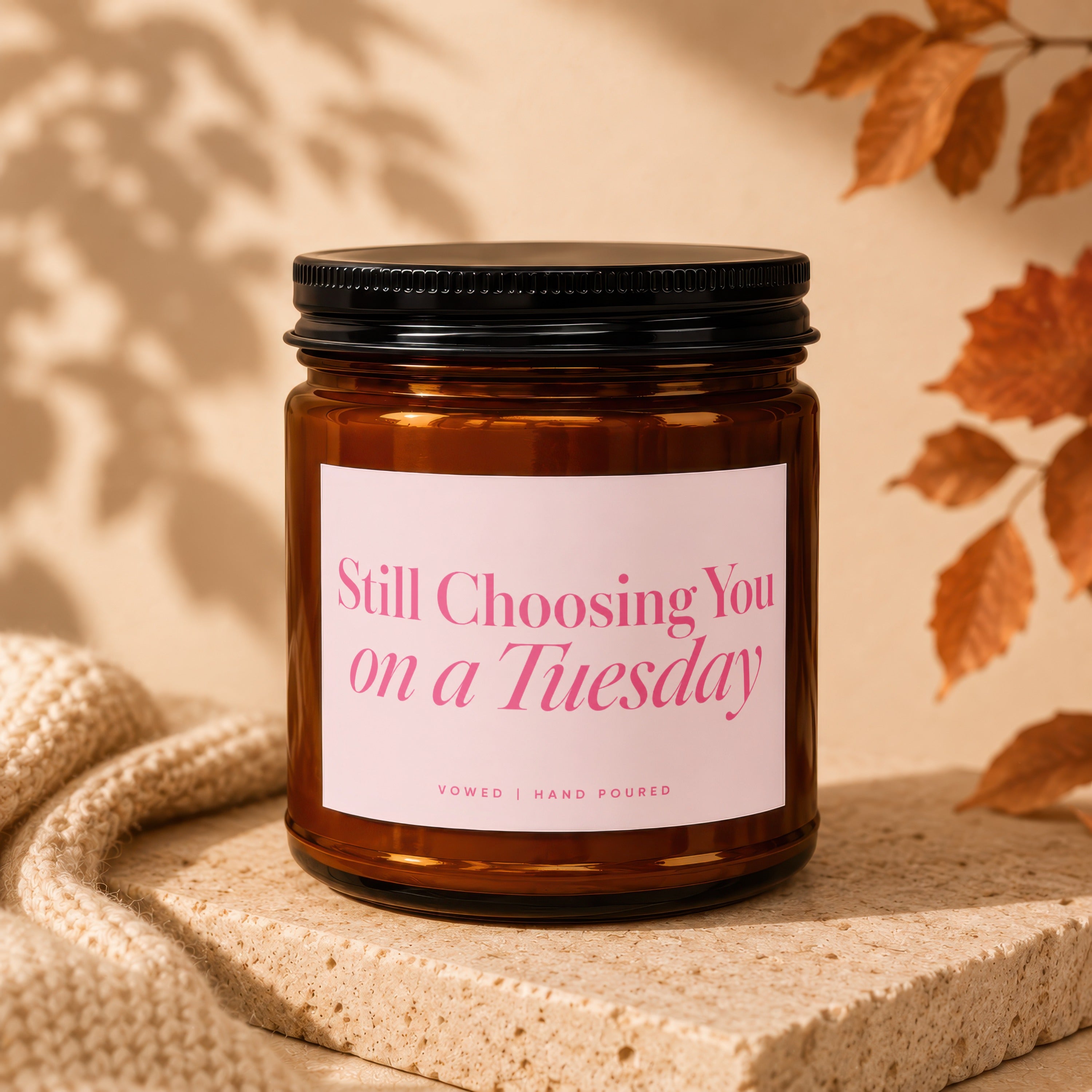 Amber jar candle with pink label reading "Still Choosing You on a Tuesday".