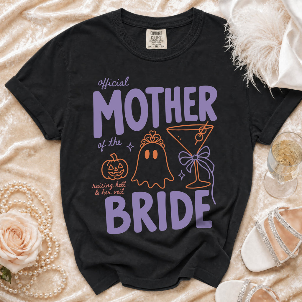 Black Comfort Colors t-shirt with "official MOTHER of the BRIDE" text and Halloween graphics.