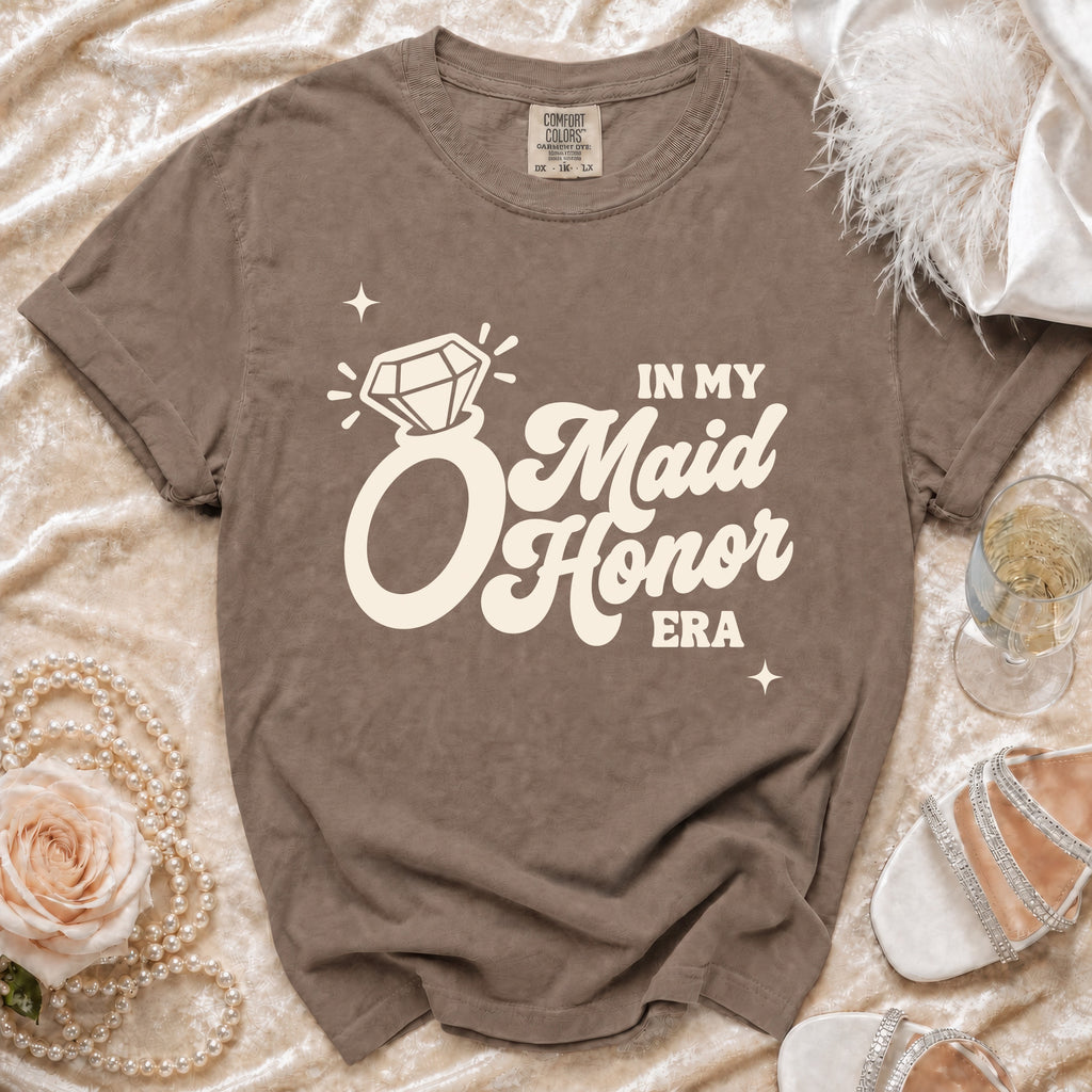 Brown t-shirt with "In My Maid Honor Era" graphic and diamond ring.