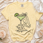 Light yellow Comfort Colors t-shirt with "This Girl Needs a Margarita" graphic.