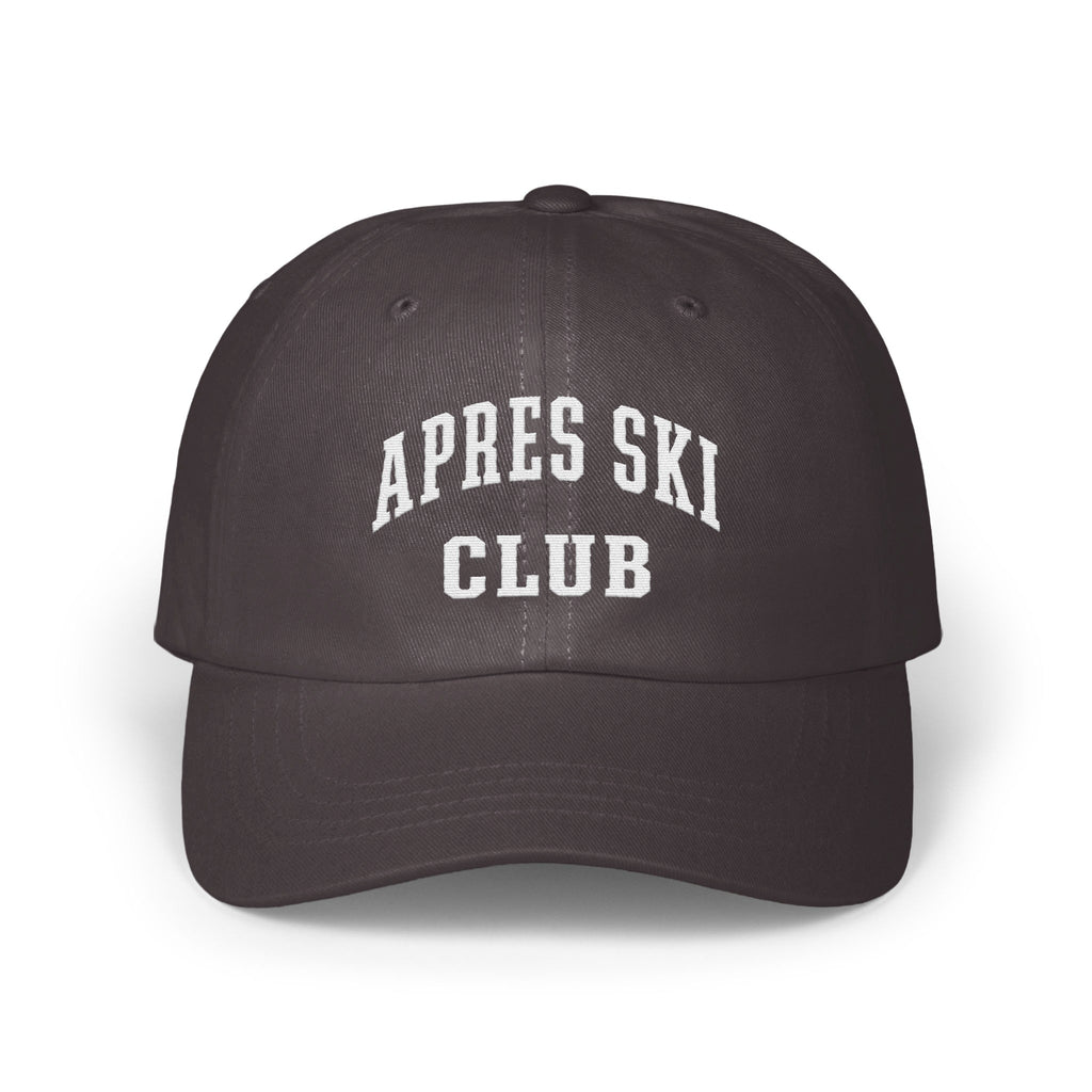 A dark grey baseball cap with white embroidered text reading APRES SKI CLUB on the front.