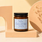 Amber glass candle jar with black lid, "My Favorite Yes VOWED" label.