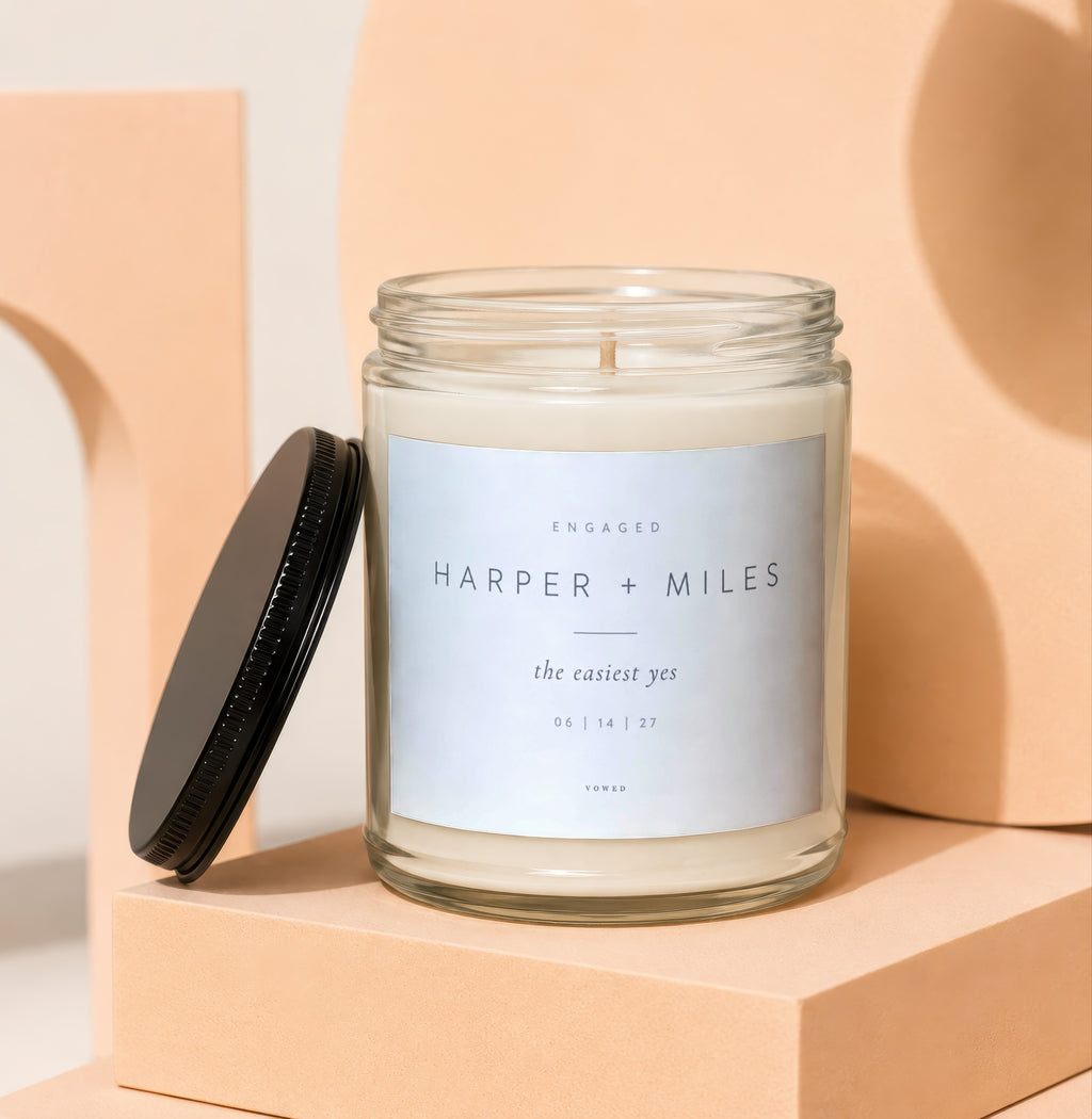 Engaged candle with label "Harper + Miles the easiest yes 06 | 14 | 27 Vowed".