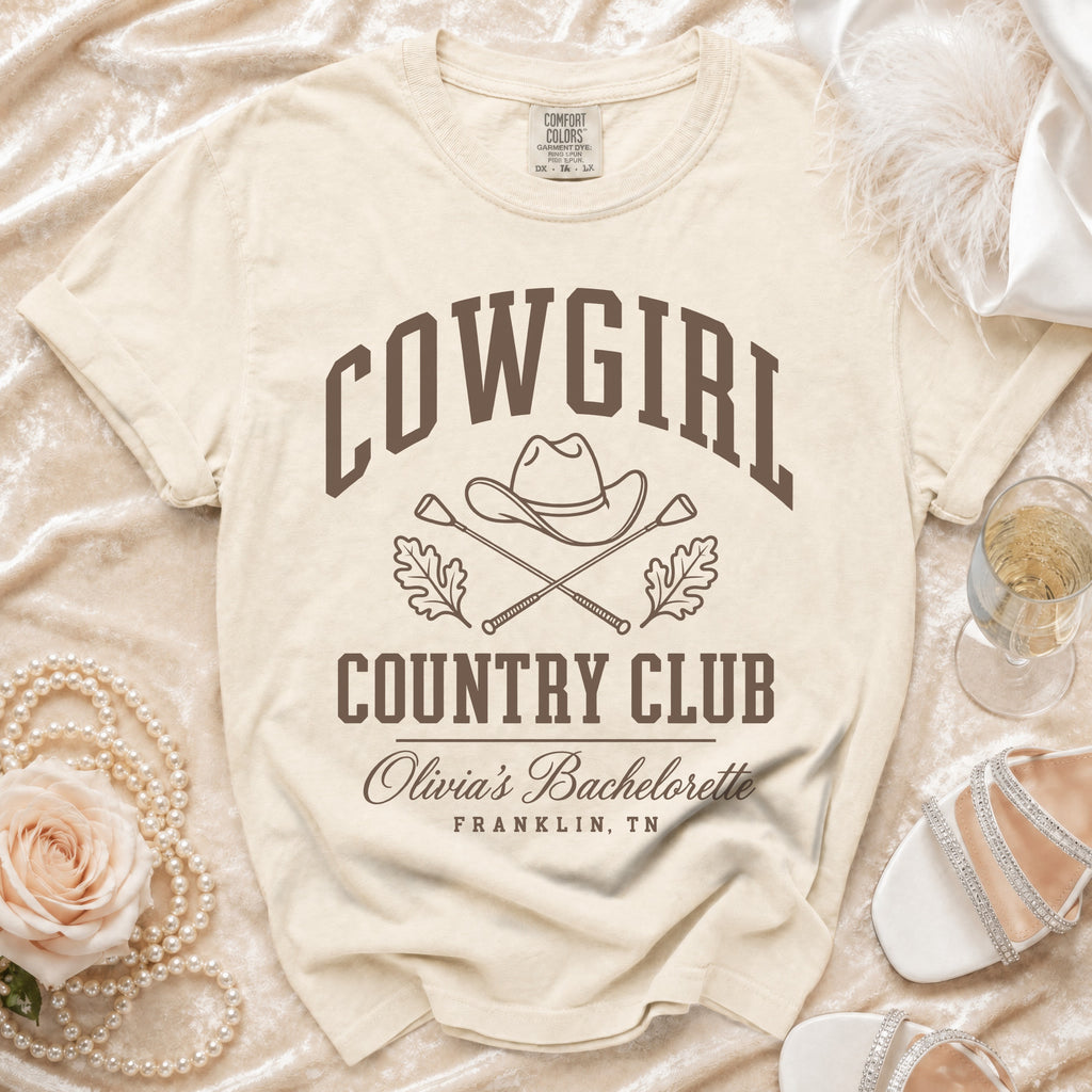 Cream t-shirt featuring brown text reading COWGIRL COUNTRY CLUB above Olivia's Bachelorette Franklin, TN.