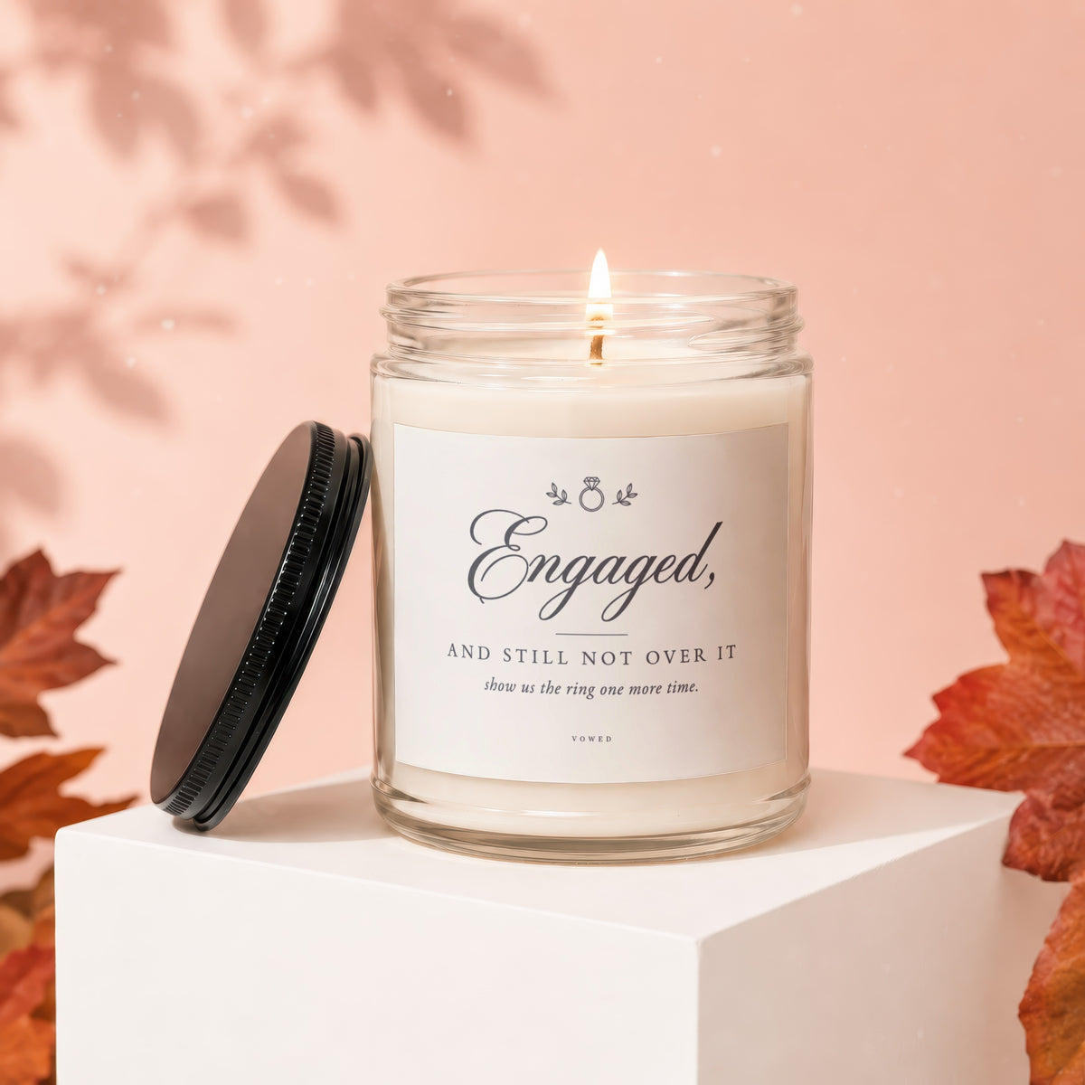 Candle with "Engaged, and still not over it" text, lit flame.
