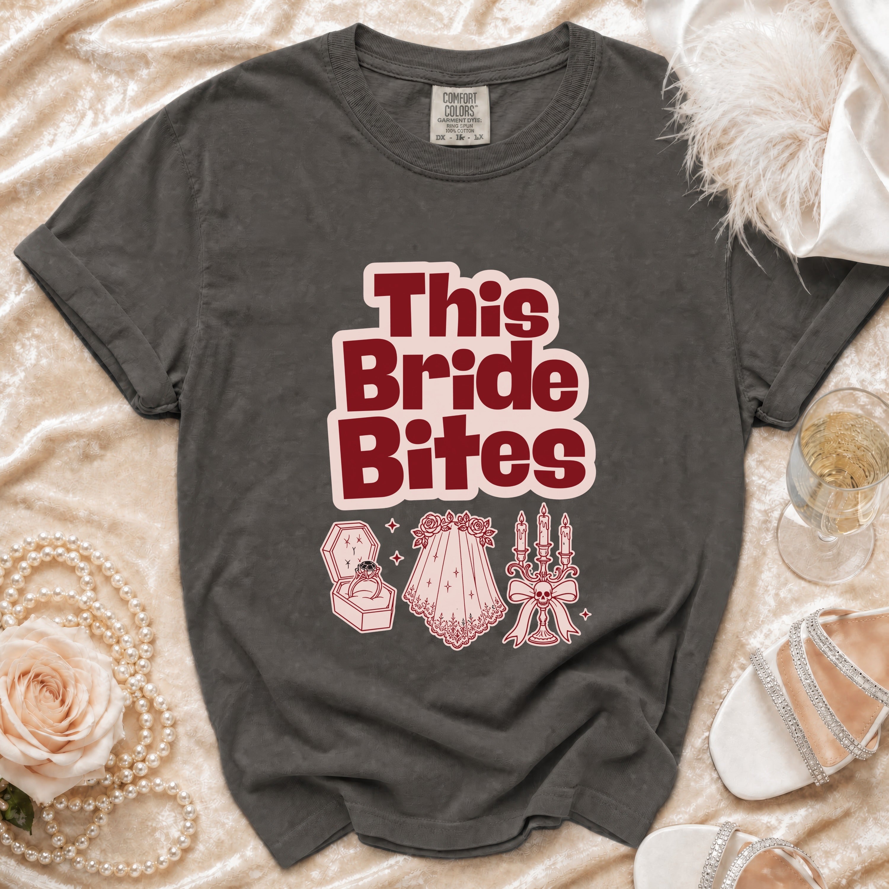 Dark grey t-shirt with "This Bride Bites" text and gothic wedding icons.