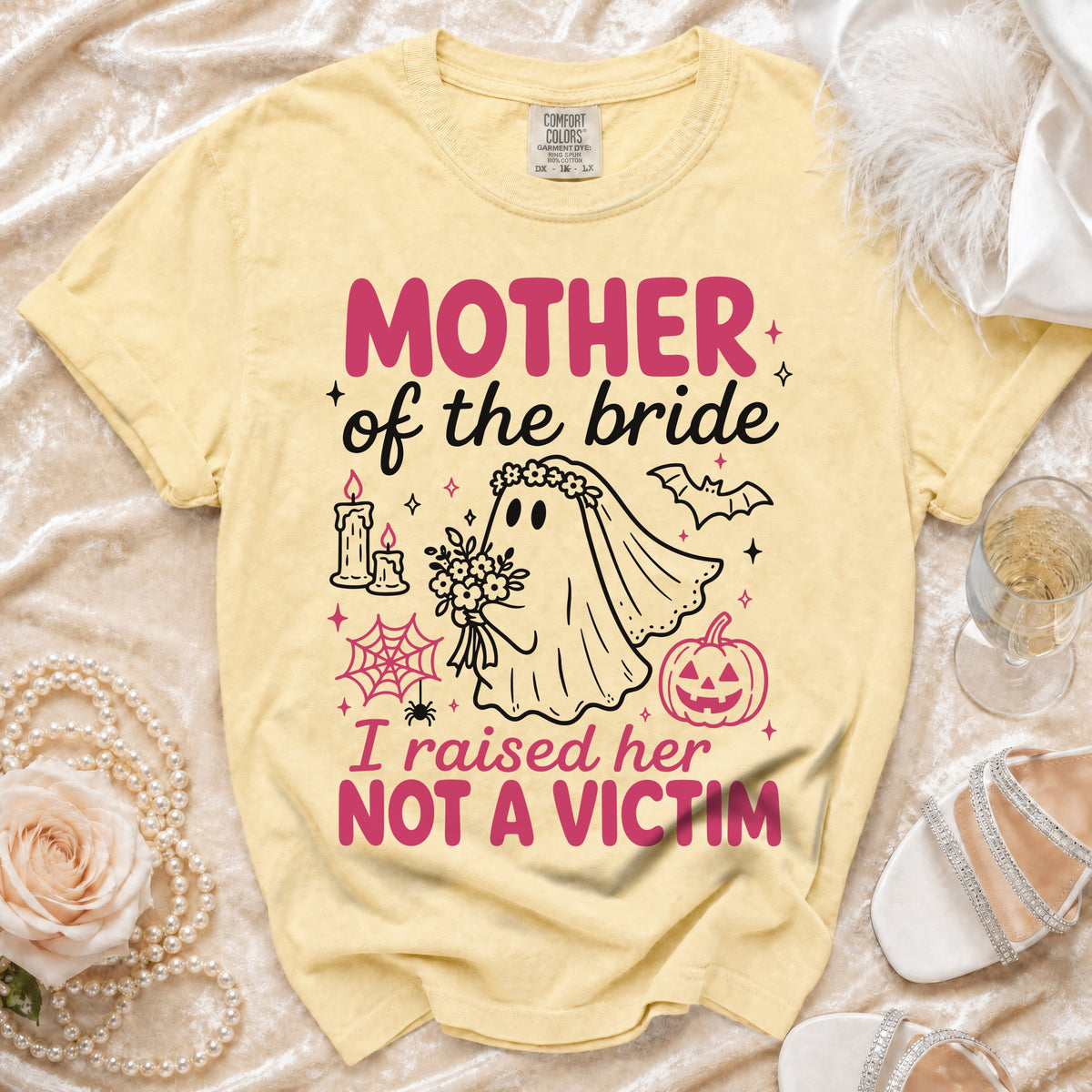 Yellow t-shirt with "Mother of the bride I raised her NOT A VICTIM" text and spooky ghost graphic.