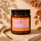 Amber jar candle with orange label reading "YEAR ONE: FIRST YEAR FAVORITES", "TWELVE MONTHS. ZERO REGRETS.", "VOWED".