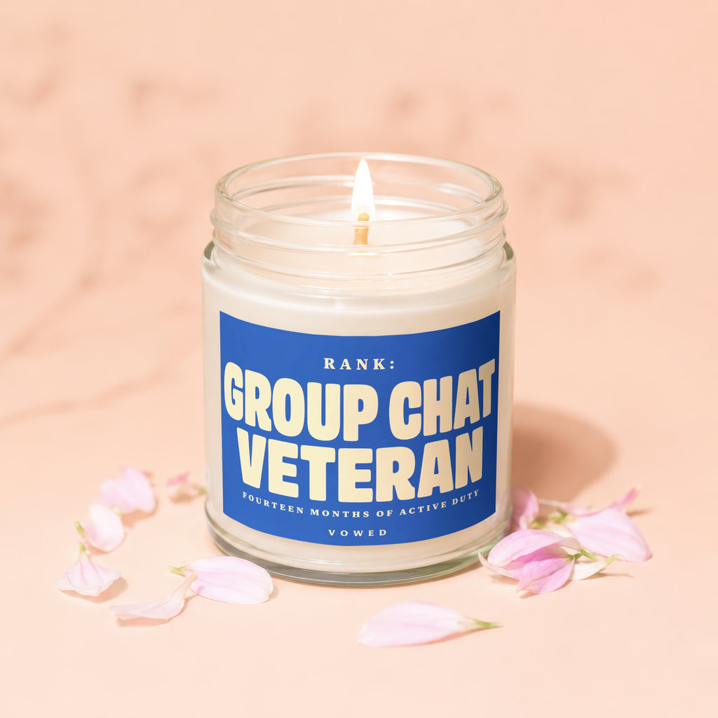 Burning candle with "Rank: Group Chat Veteran" on blue label surrounded by petals.