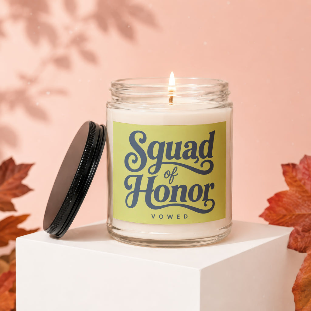 Glass candle with lit wick and "Squad of Honor VOWED" text on label.