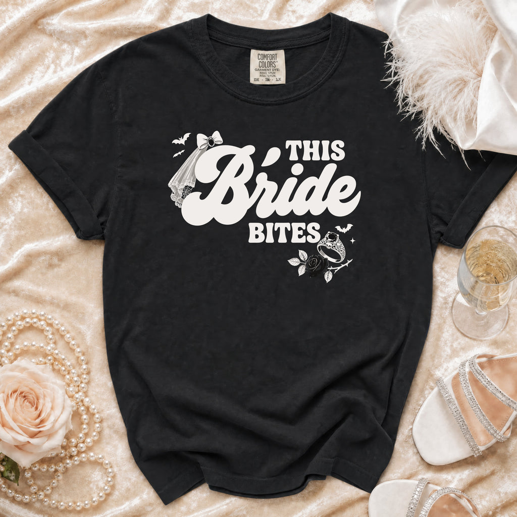 Black t-shirt with "This Bride Bites" graphic and wedding accessories.