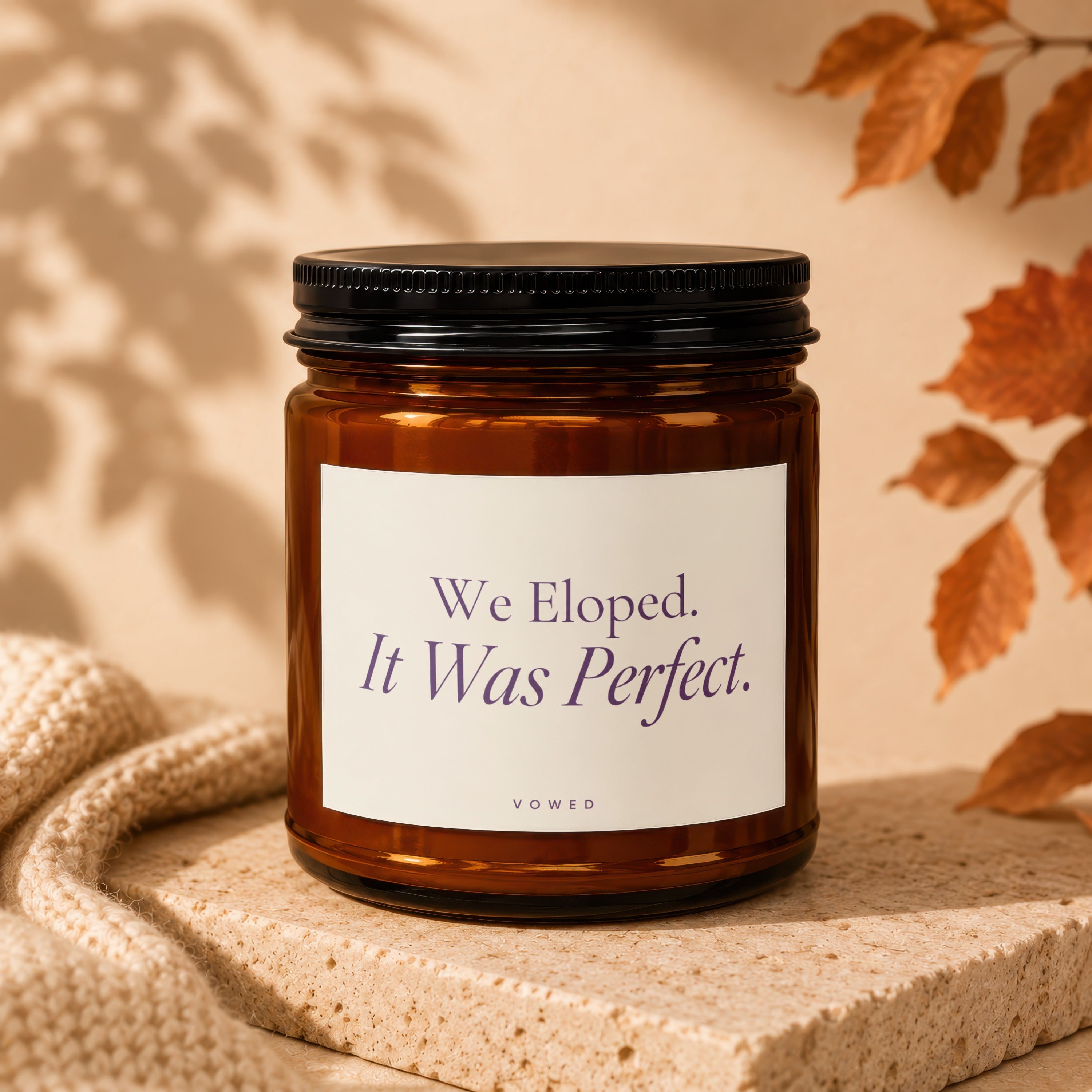 Amber candle with Vowed label reading "We Eloped. It Was Perfect."