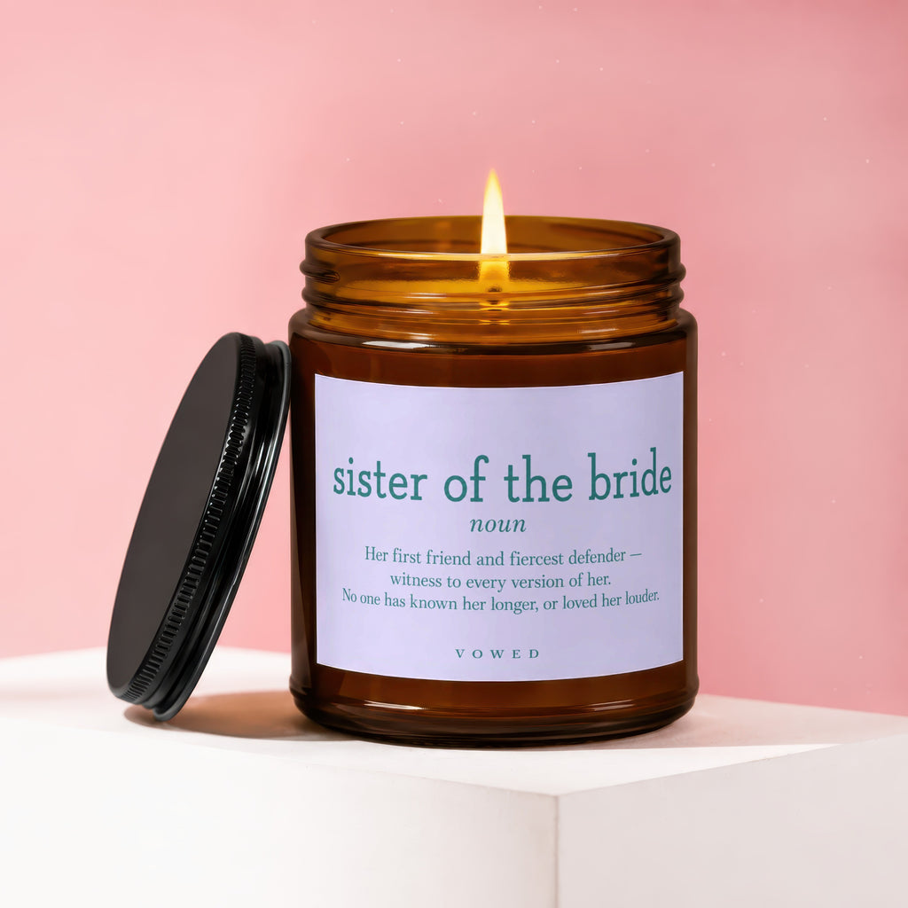 Candle labeled "sister of the bride" with a quote and lit flame.