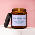 Candle labeled "sister of the bride" with a quote and lit flame.