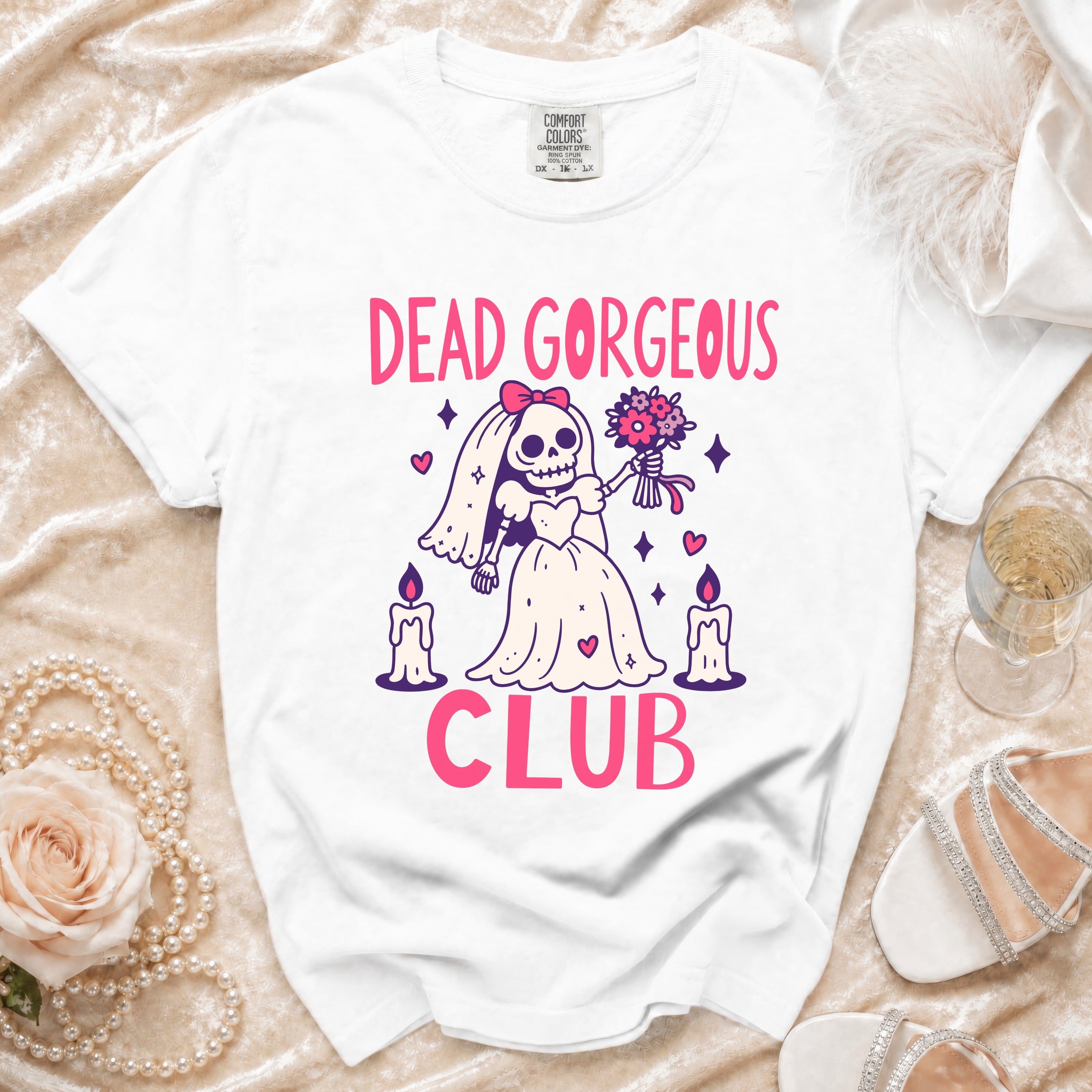 White t-shirt with "DEAD GORGEOUS CLUB" text and skeleton bride graphic.