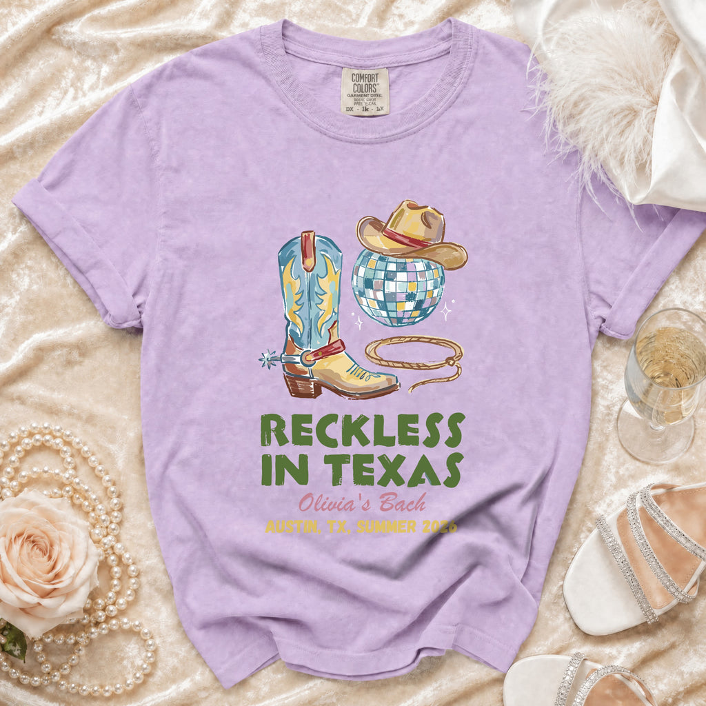 Purple t-shirt with cowboy boots, hat, disco ball, and text.