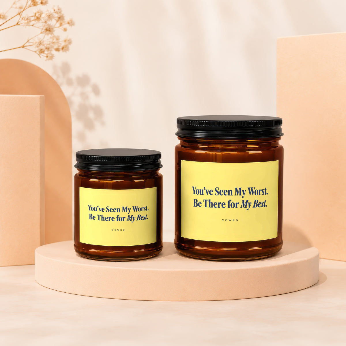 Two amber glass candles with yellow labels that say "You've Seen My Worst. Be There for My Best."