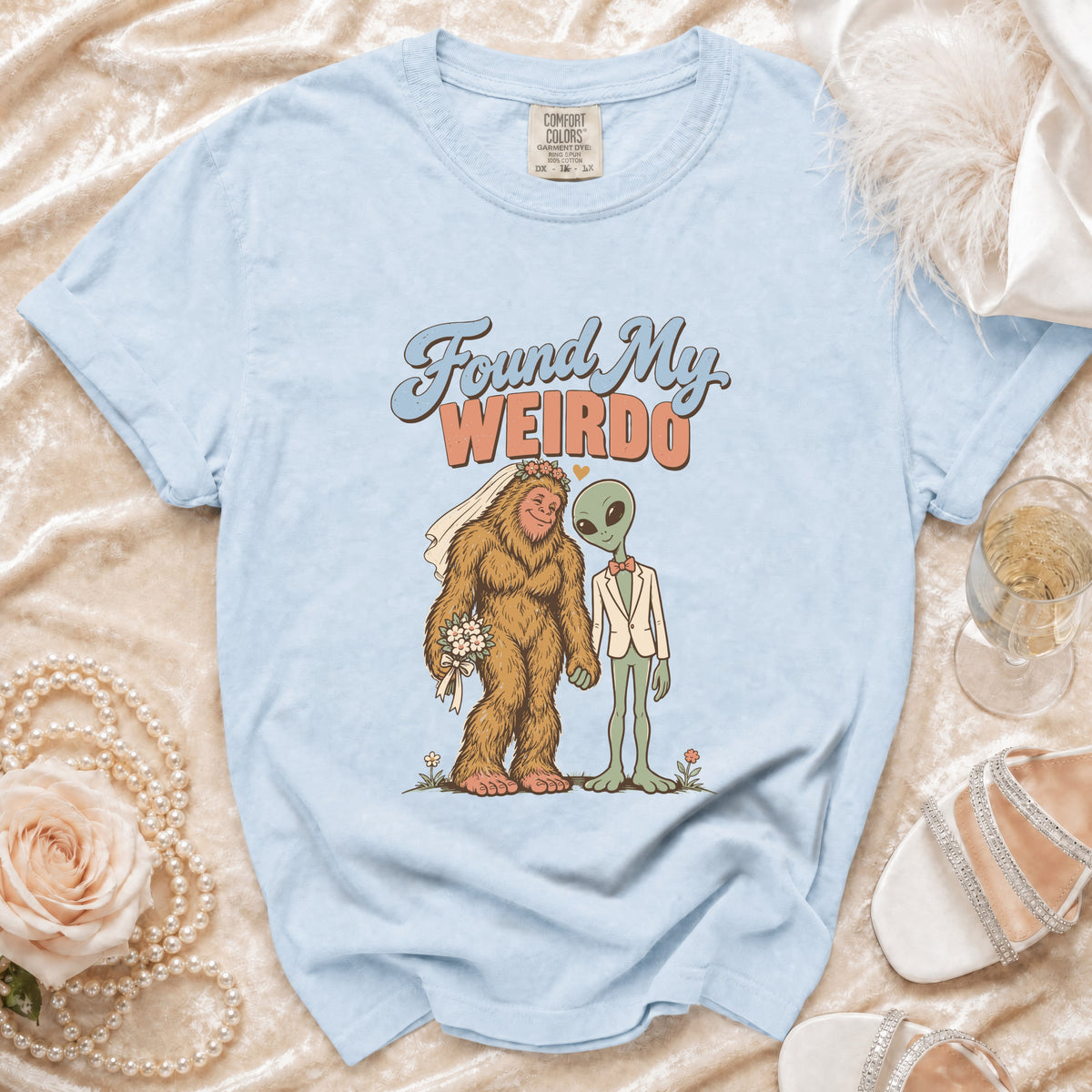 Light blue t-shirt with "Found My WEIRDO" and Bigfoot alien wedding graphic.