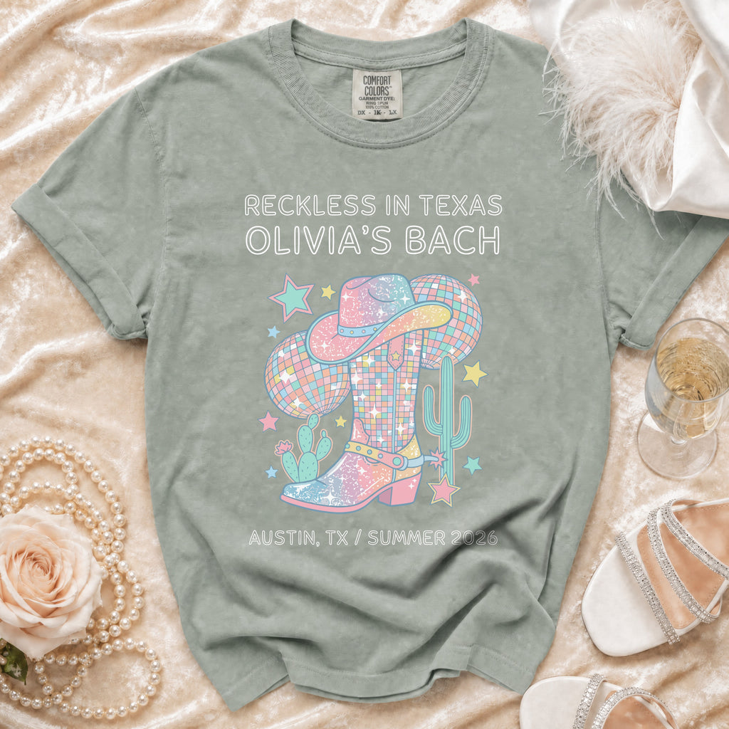 T-shirt with "Reckless in Texas Olivia's Bach" and Western graphics.