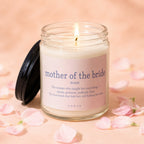 Candle with "mother of the bride" definition on label, with lit wick.