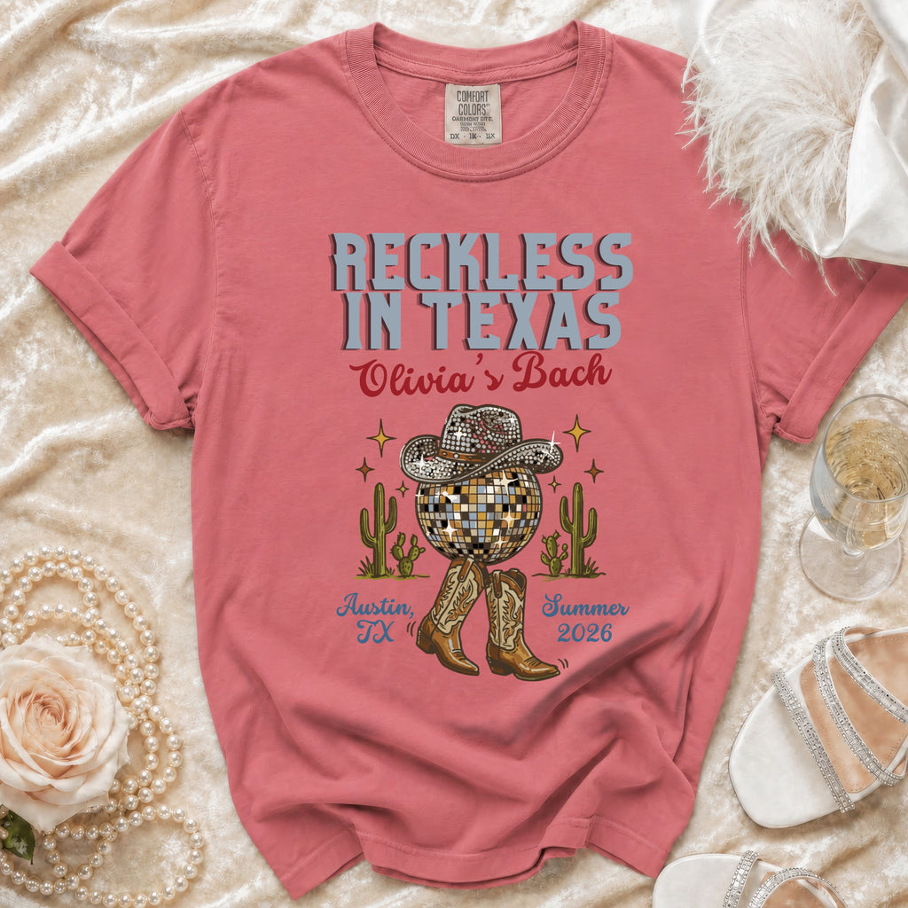 Coral t-shirt with "Reckless in Texas" and disco ball graphics.