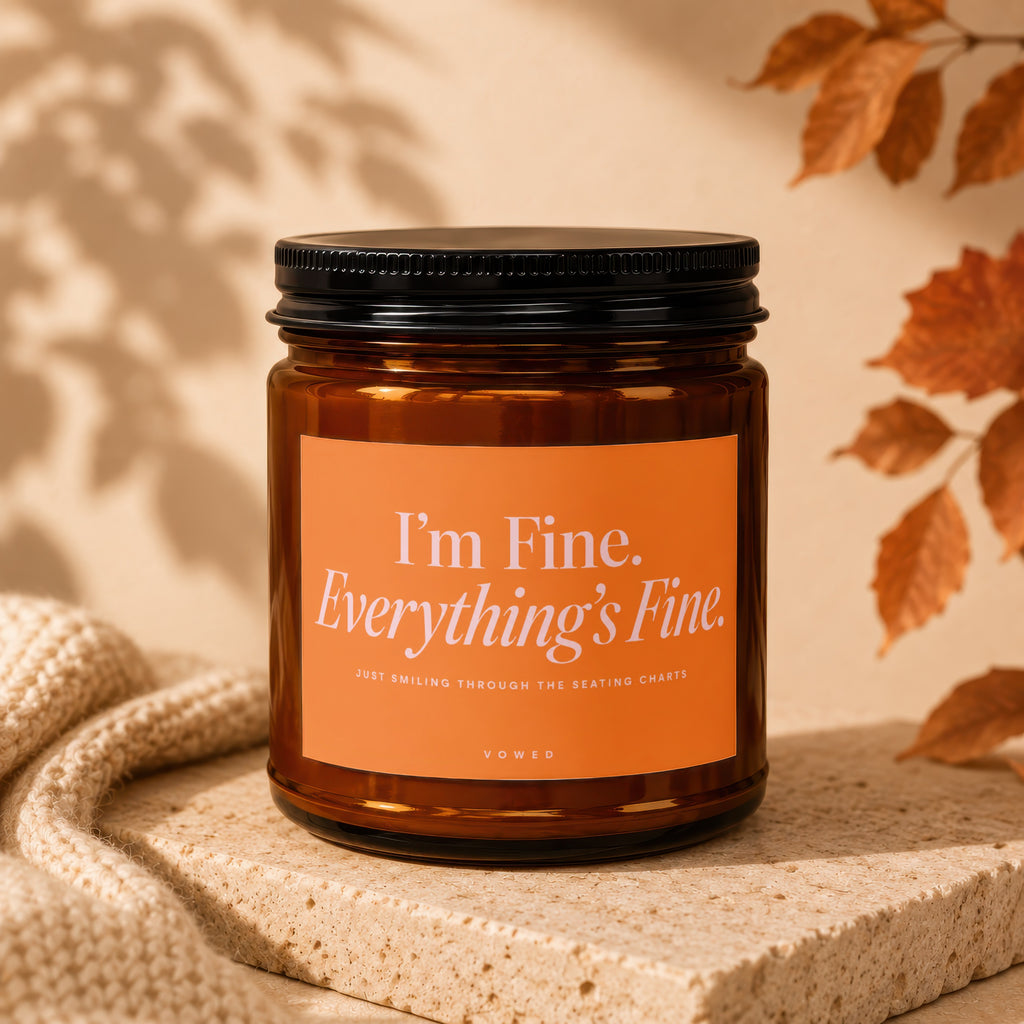 Amber candle with black lid, orange label reading "I'm Fine. Everything's Fine."