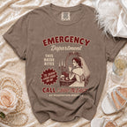 Brown t-shirt with "EMERGENCY DEPARTMENT THIS BRIDE BITES" graphic and phone number.