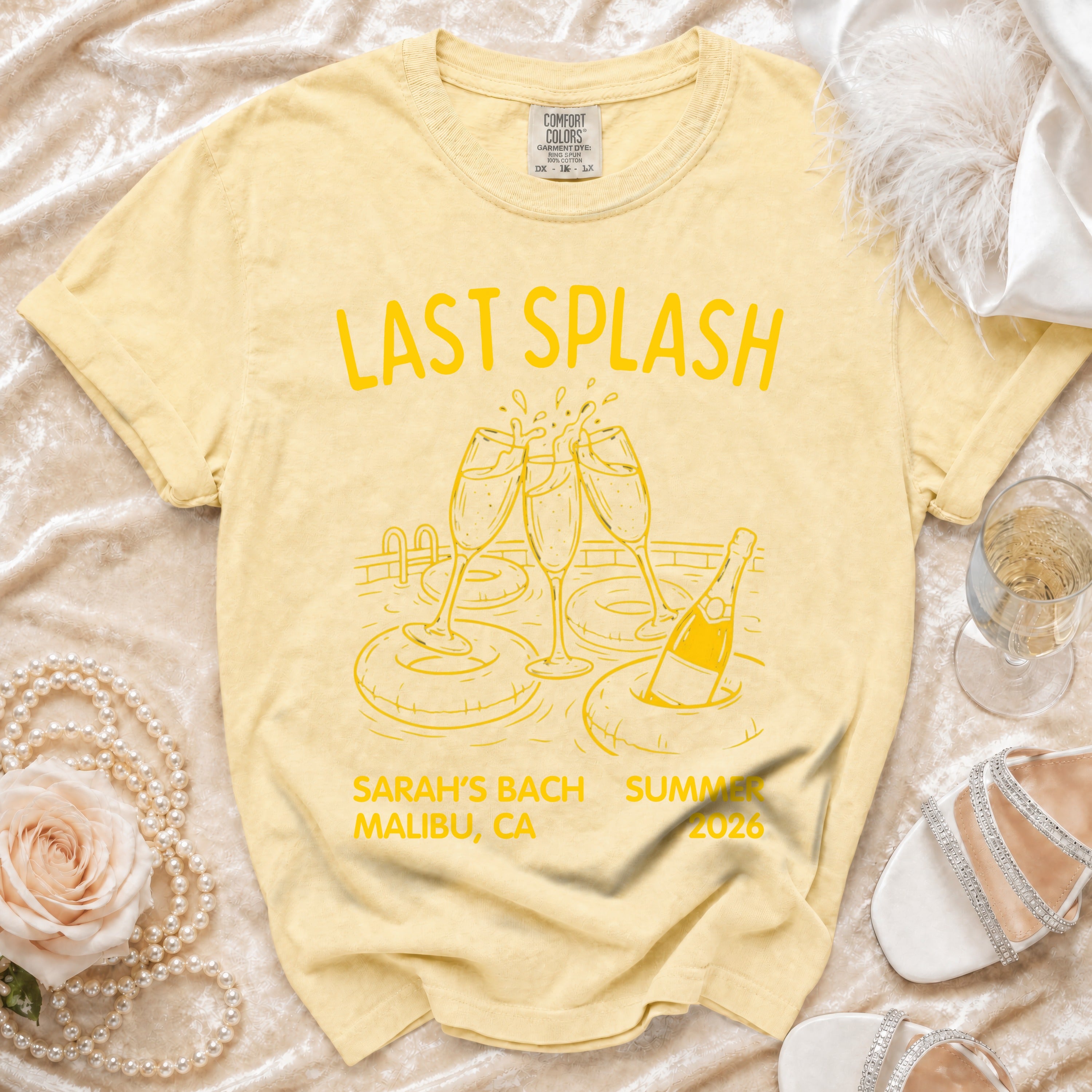 Yellow t-shirt with "Last Splash Sarah's Bach Summer Malibu, CA 2026" and champagne graphic.