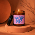 Amber jar candle with pink label reading "WIFED UP." below "vowed."