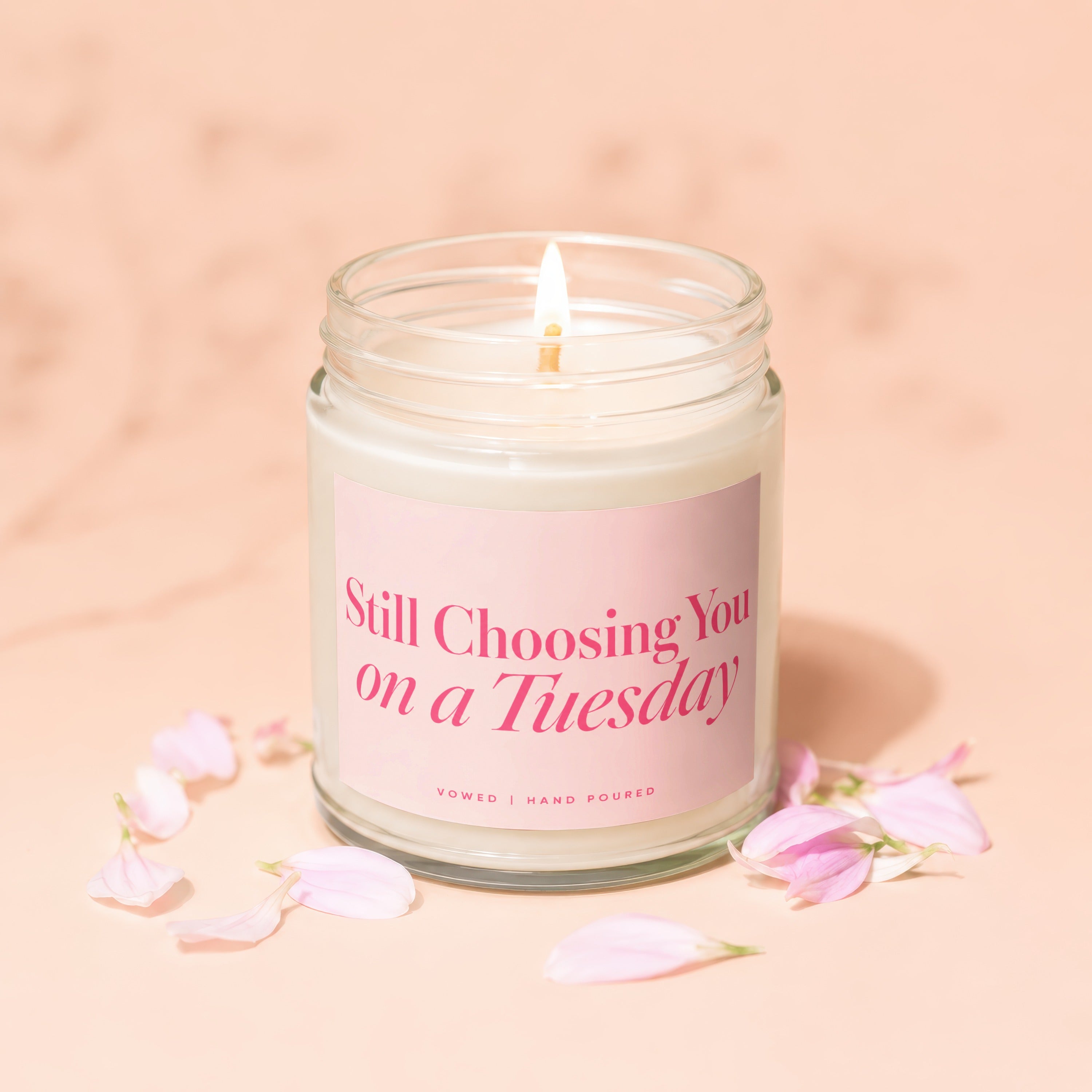 Glass jar candle with pink label reading "Still Choosing You on a Tuesday".