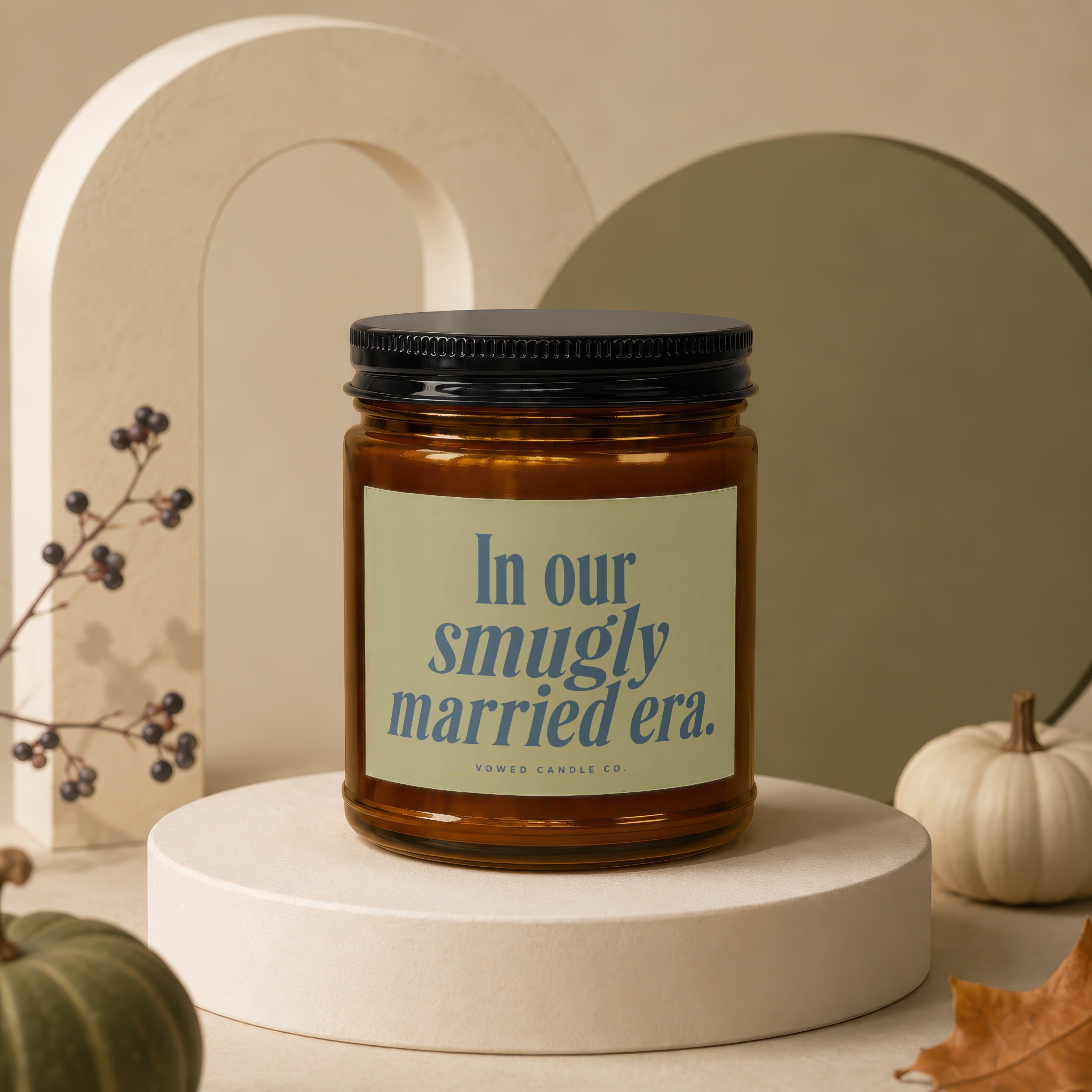 Amber glass candle with label reading "In our smugly married era."