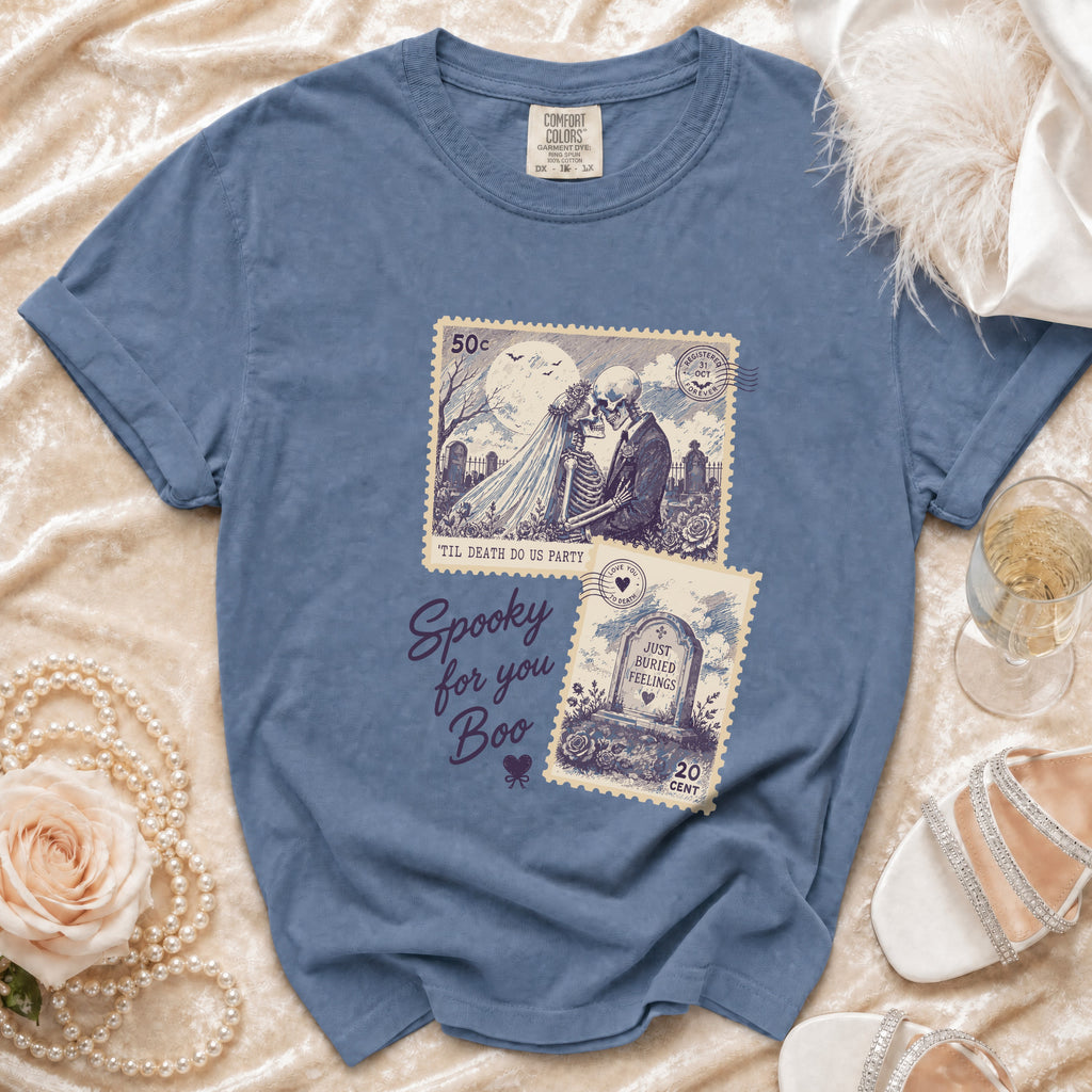 Blue t-shirt with skeleton wedding, tombstone, and text graphics.