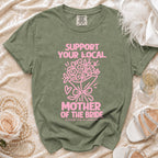 Green t-shirt with pink text "SUPPORT YOUR LOCAL MOTHER OF THE BRIDE LIFETIME JOB. NO DAYS OFF."